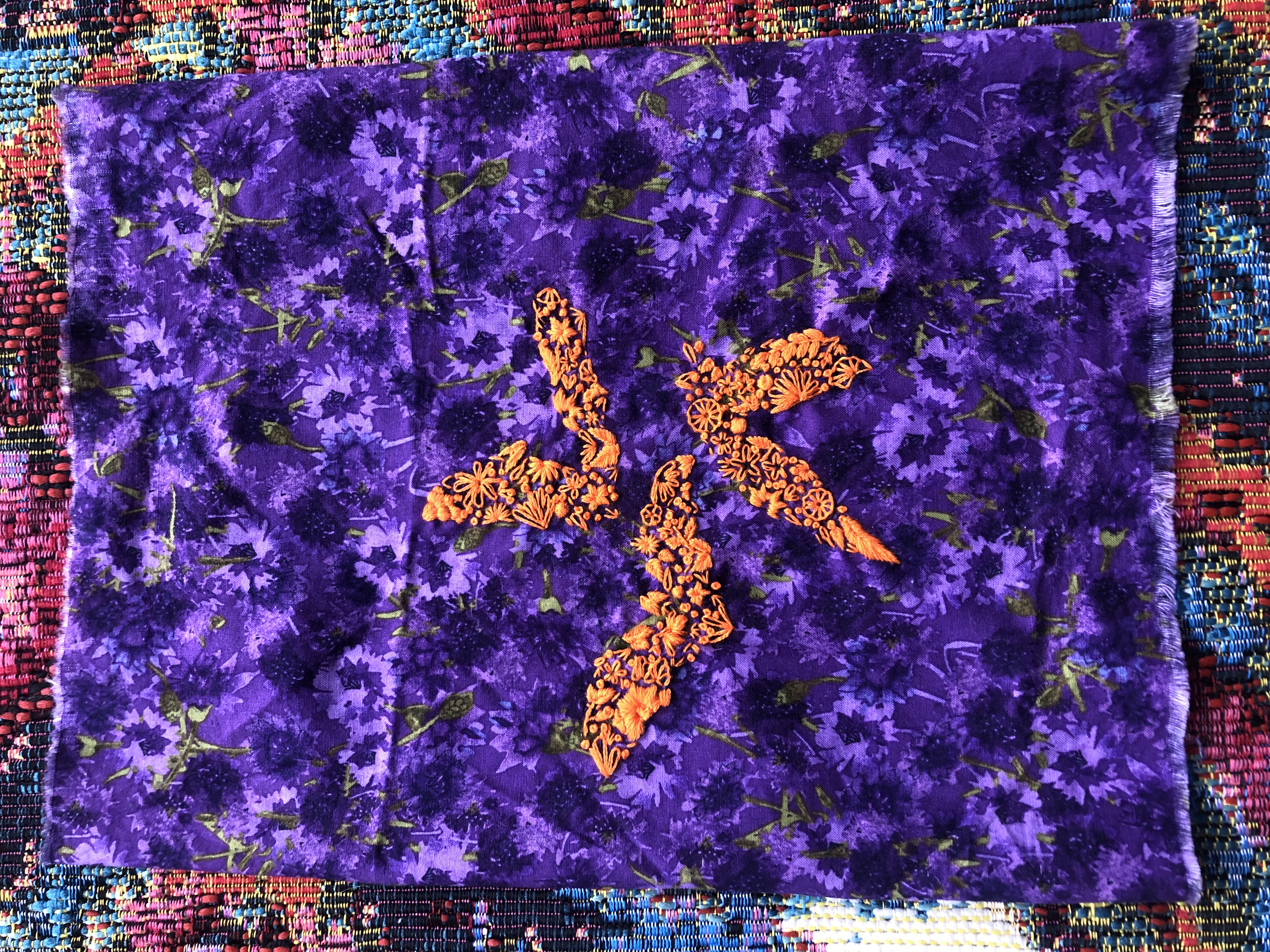 An embroidery. Bats
					outlined through using several different stitch techniques
					to create an abstract effect