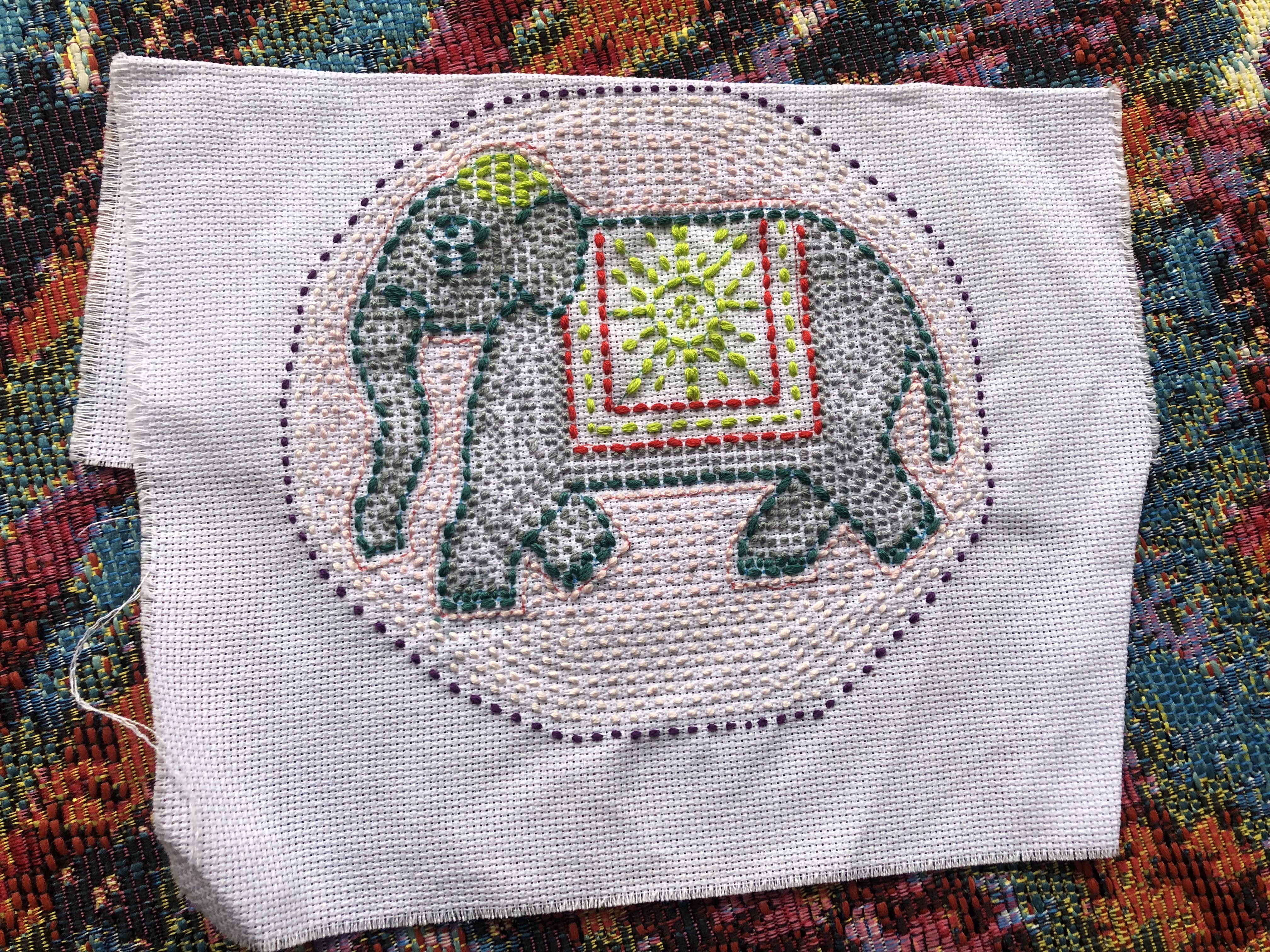 An embroidery. An elephant
					outlined in a basic backstitch