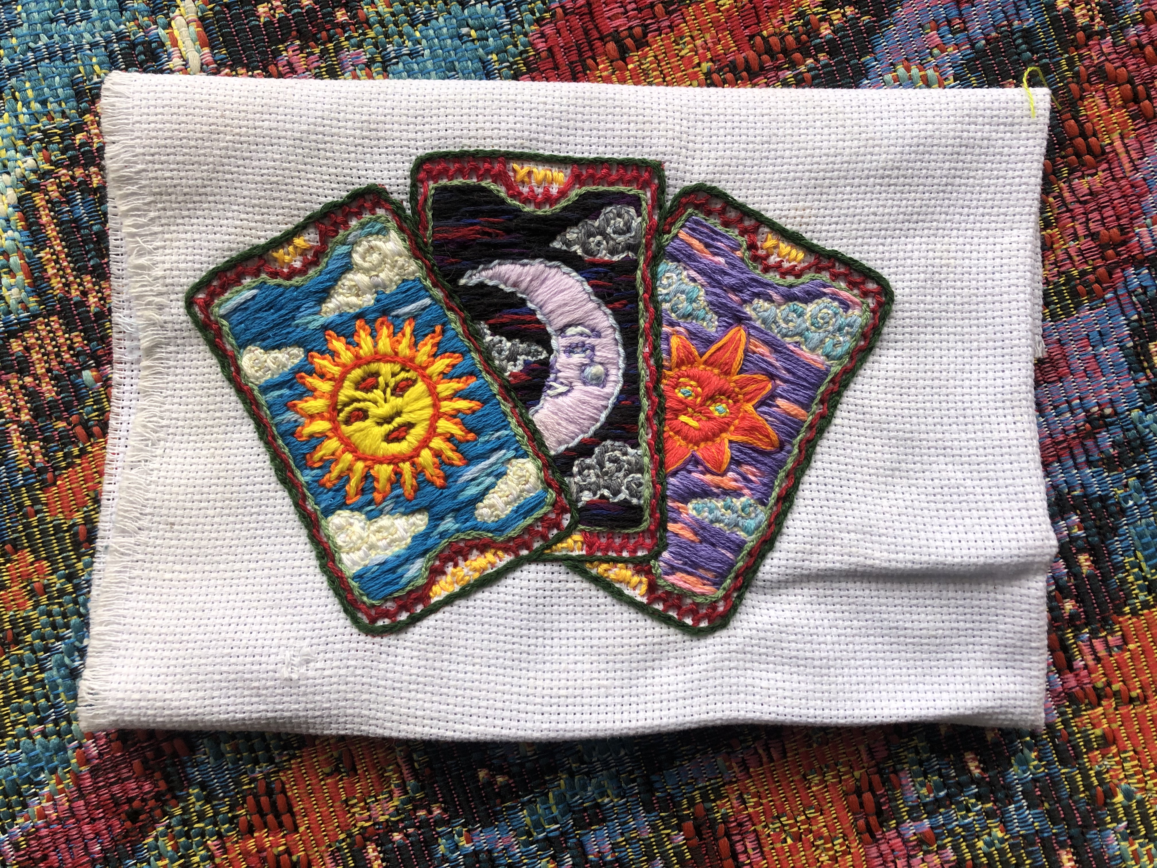 embroidered tarot
					cards- the sun at midday, the sky at night, and the sun in
					the evening